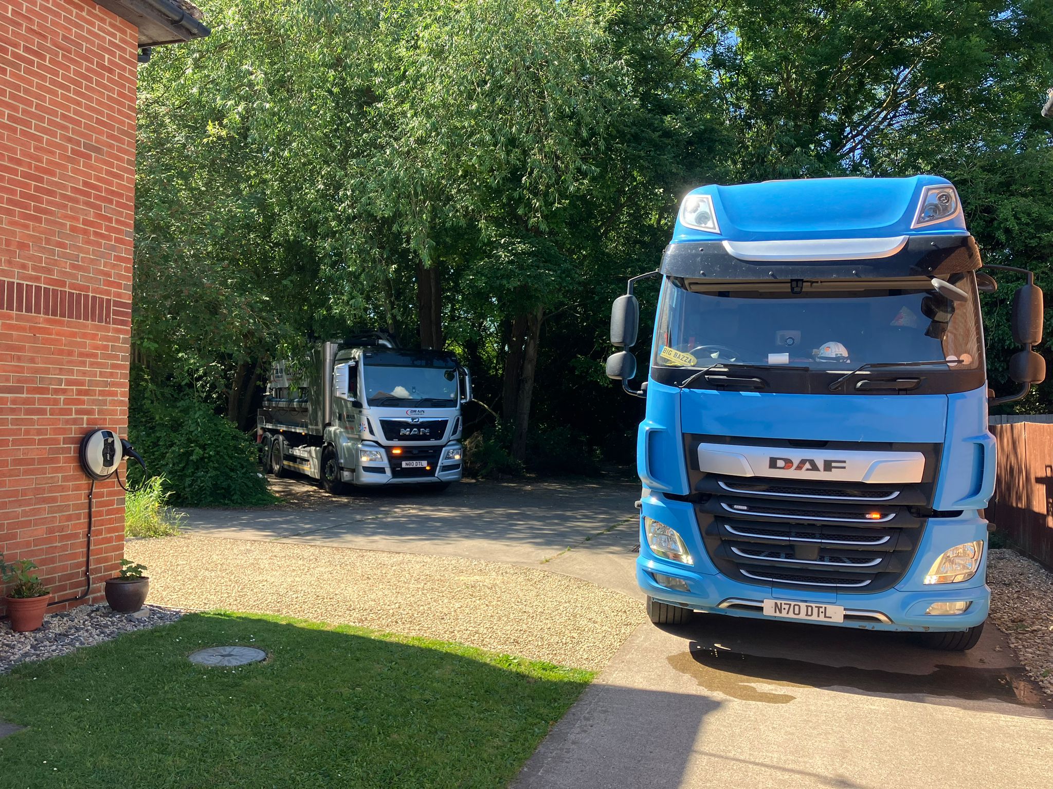 Two Drain Technology lorries parked on a driveway