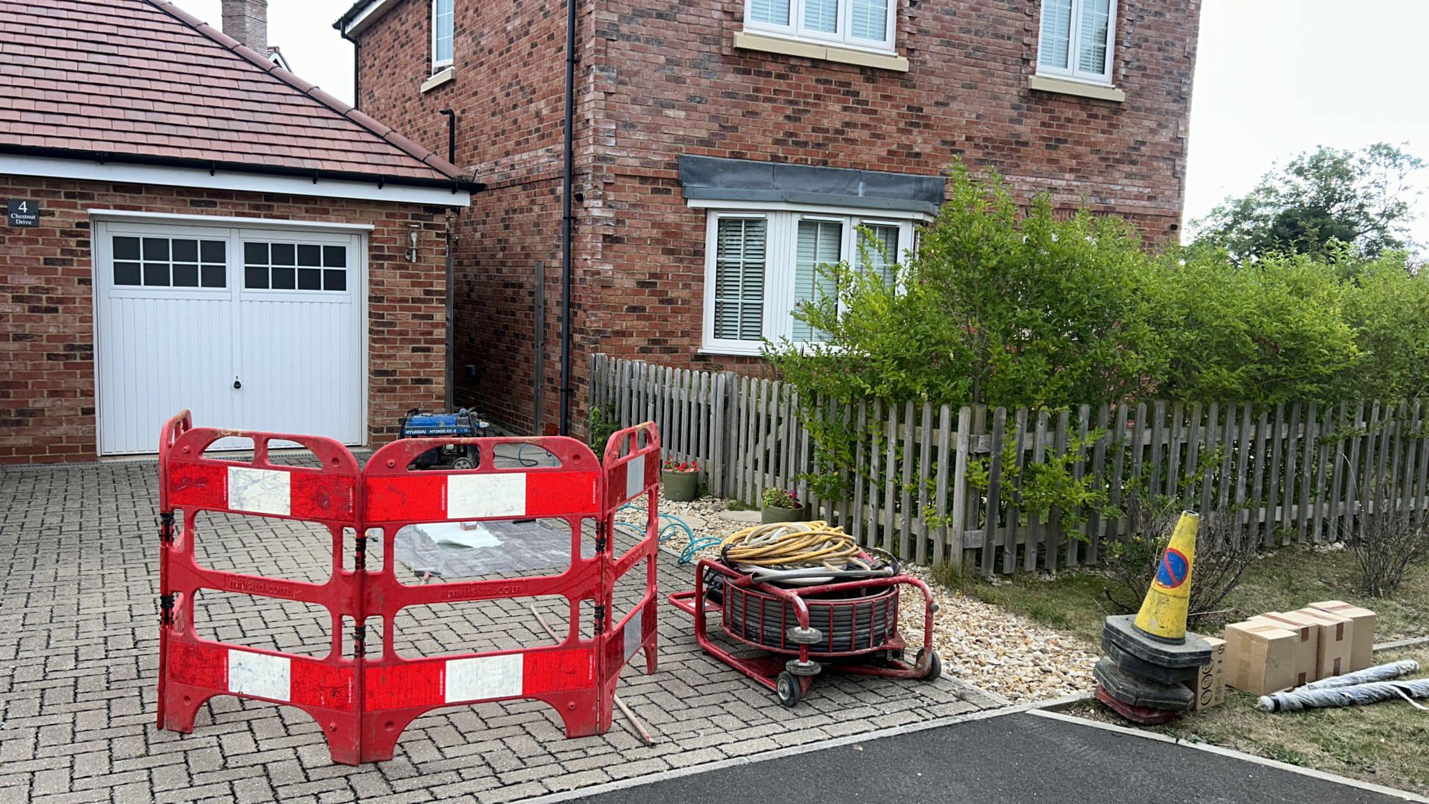 Driveway with drain repair equipment on.