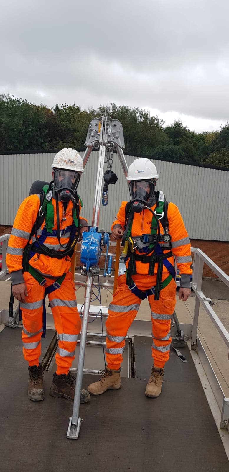 Two people in high vis work gear