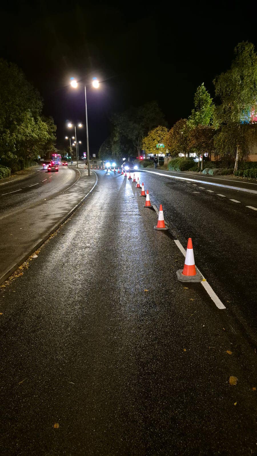 Traffic cones on road at night time.