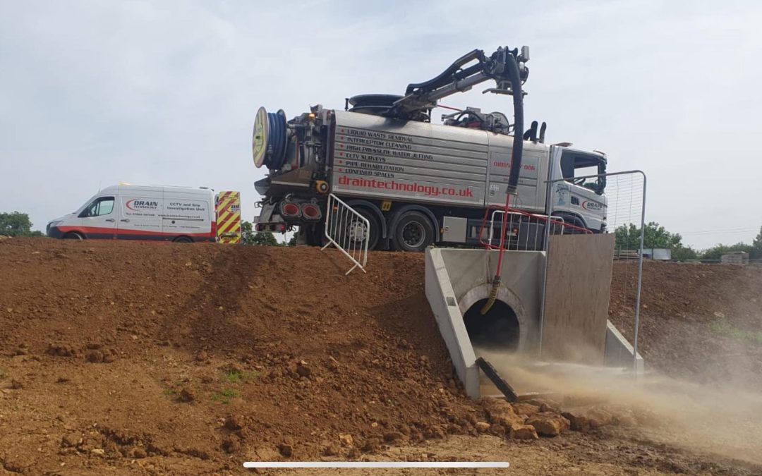 Cleaning a large storm drain from above the headwall