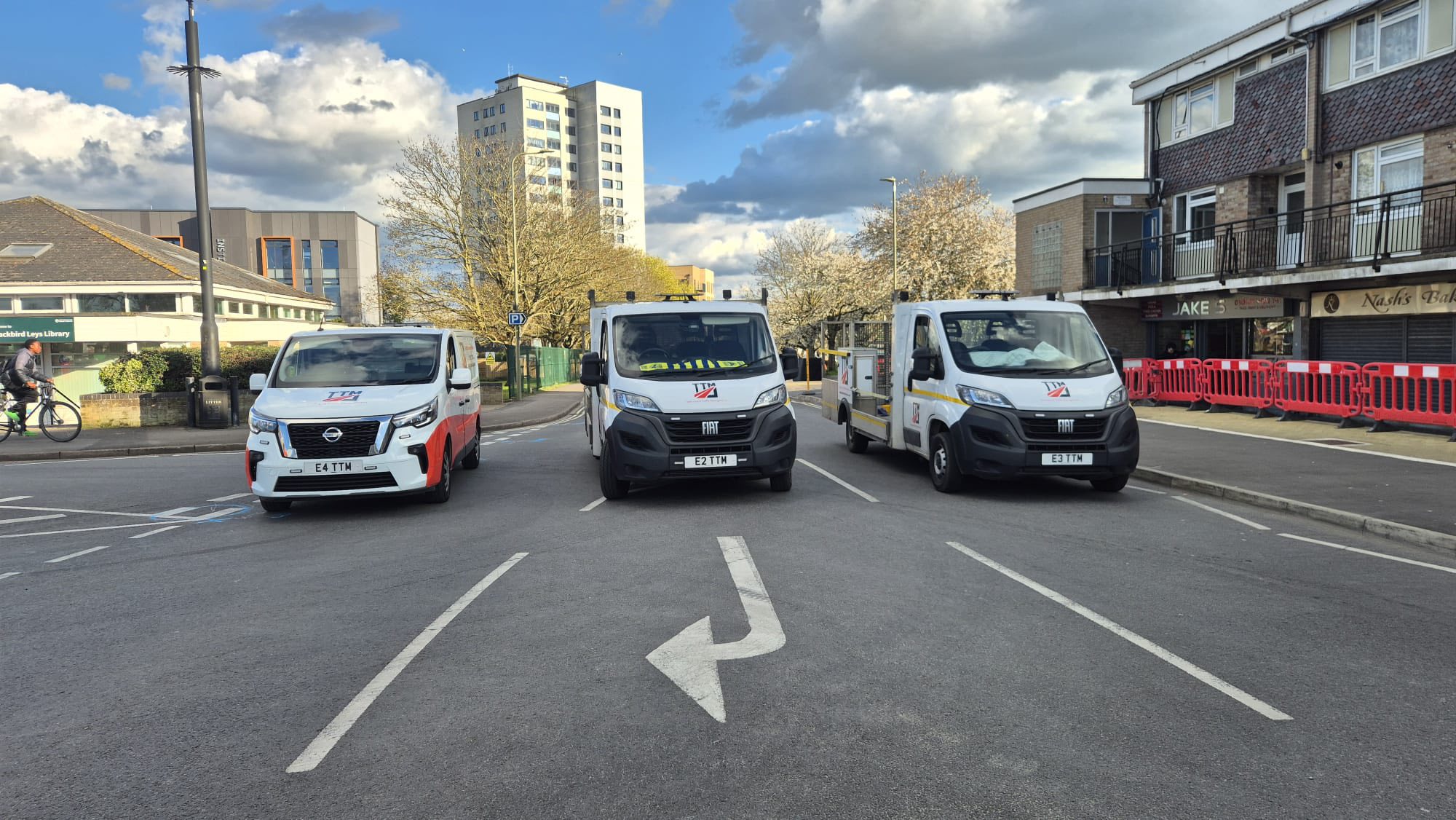 Front view of three TTM vans performing a road block.
