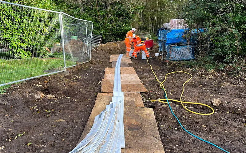 Three men in hi vis uniform working on groundworks project