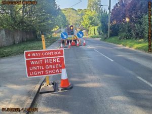 4 - way control traffic sign leading to temporary traffic lights on a road