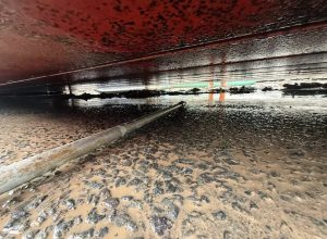 Cleaning under a weighbridge