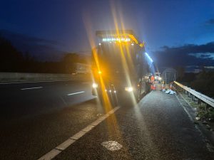 Lorry on a side of a road in the dark