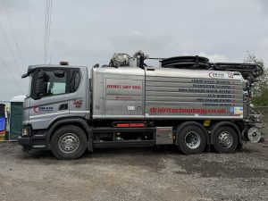 Grey truck with Drain Technology branding 