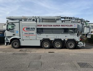 Grey truck with Drain Technology branding and equipment