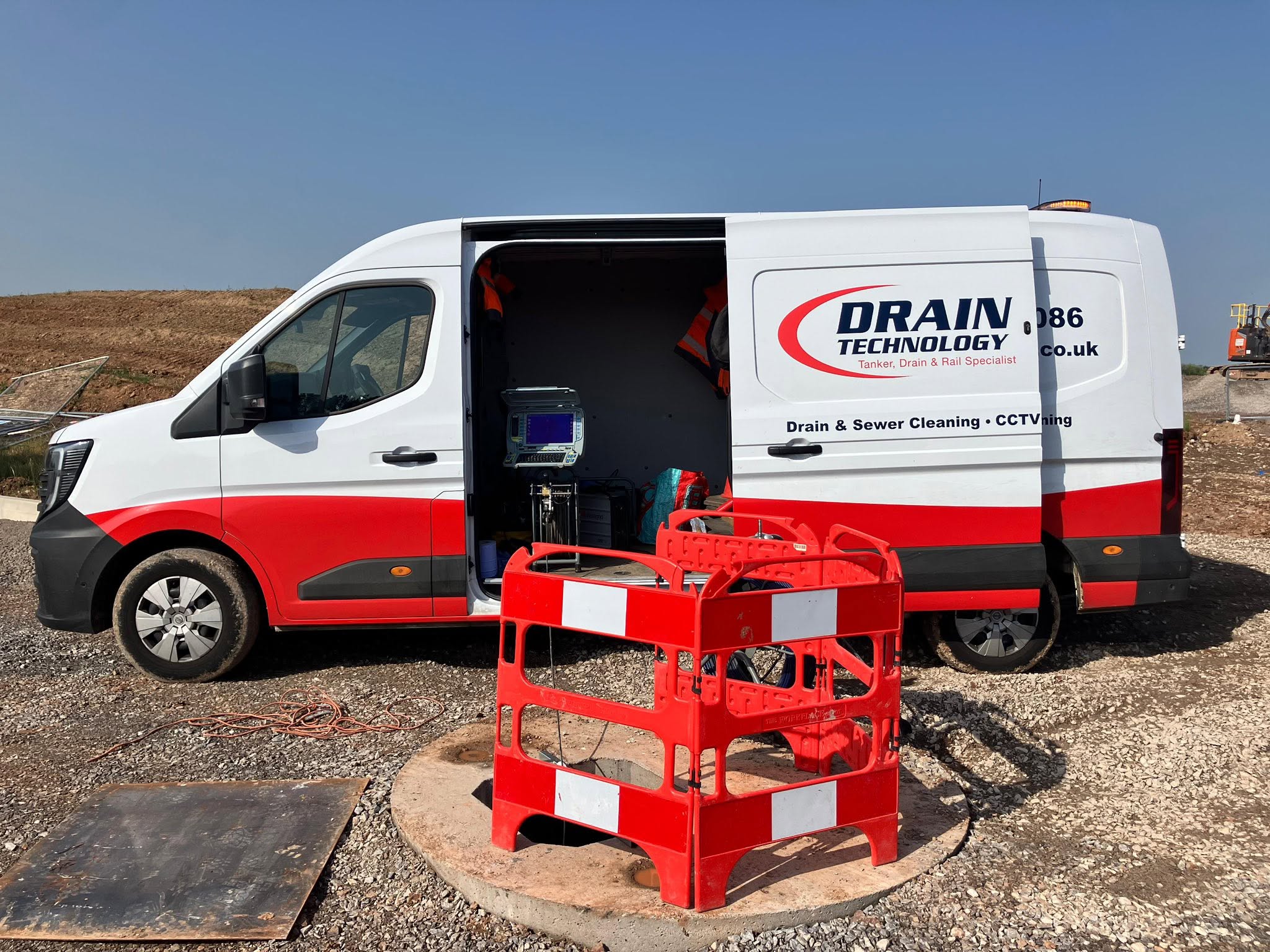 Drain Tech van on site with a barrier up