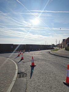 Sunny sky with traffic cones lining the road