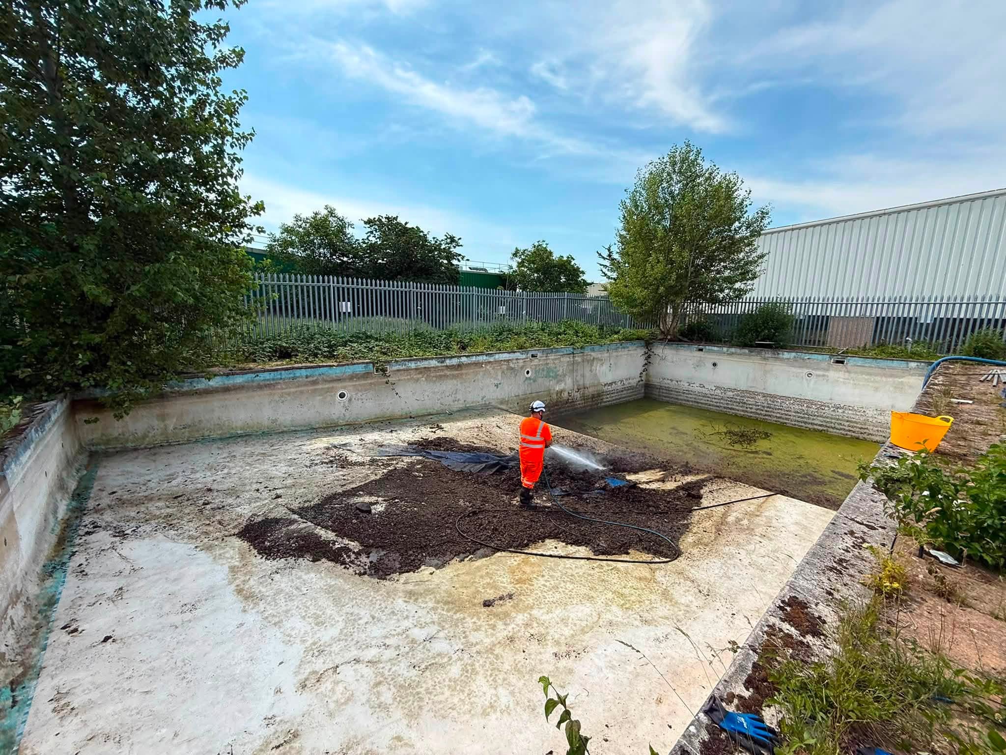 DT News 1 Man cleaning a large pool