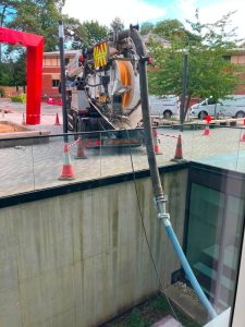 White lorry pumping from a building