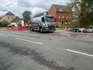 Grey lorry on the side of a residential road