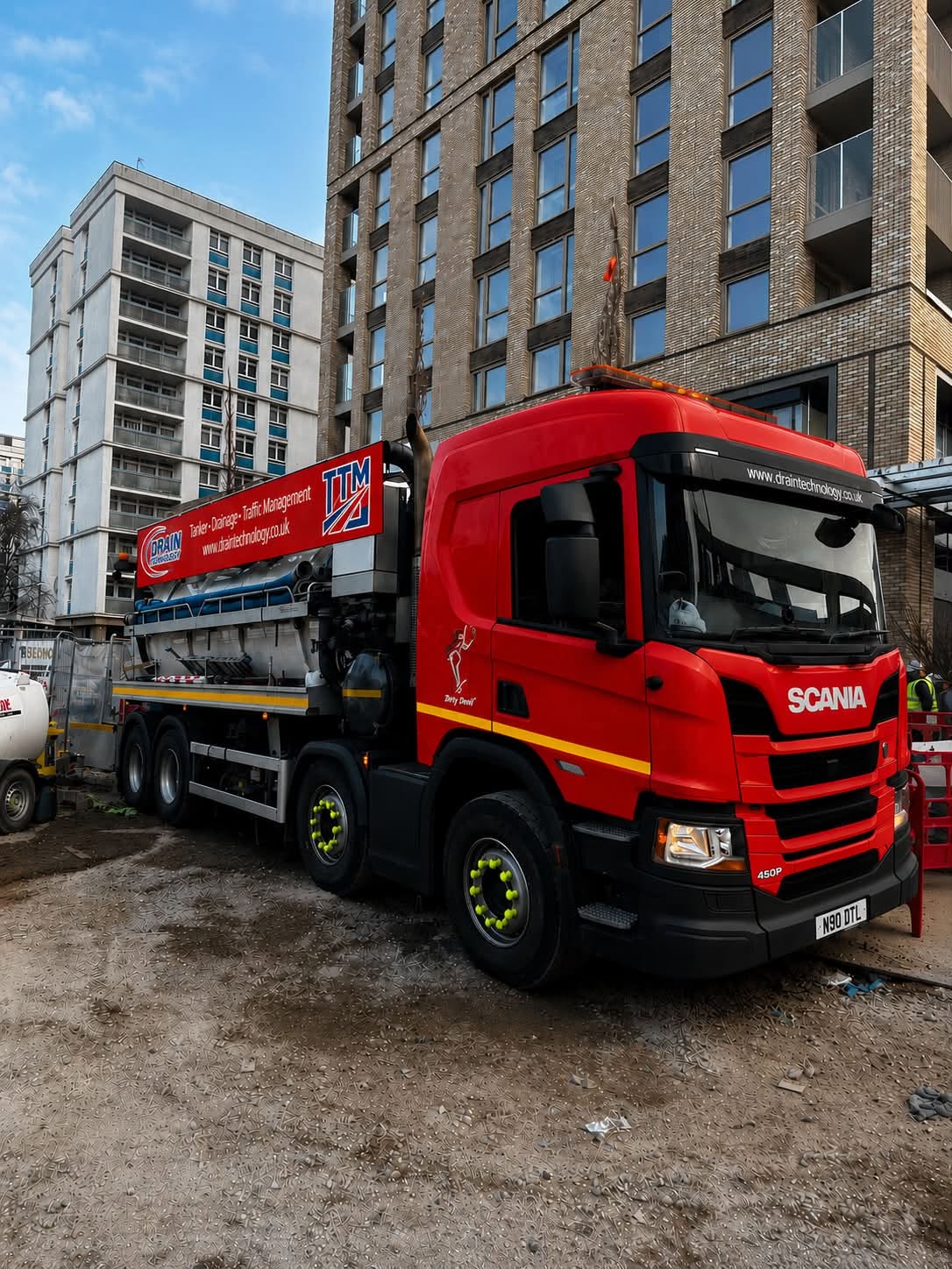 Drain Tech news 13:7 red lorry in a urban area