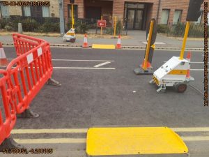 Road work signs, barriers and temporary lights creating a crossing for pedestrians on a road