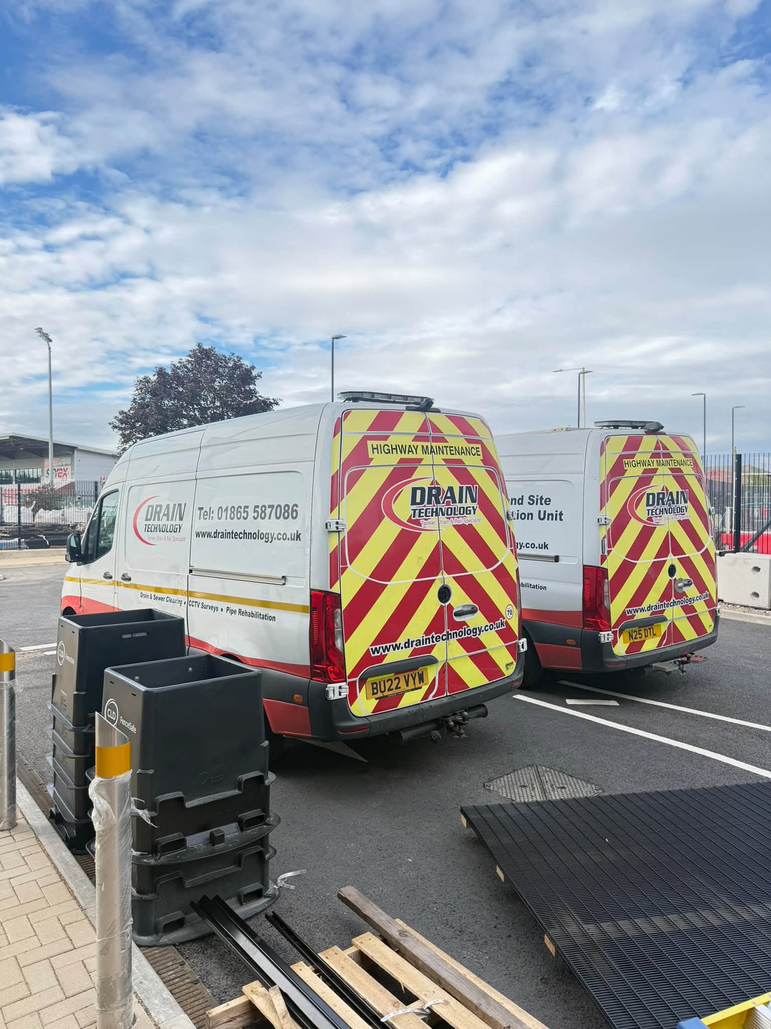 Drain Technology vans parked in a road with equipment