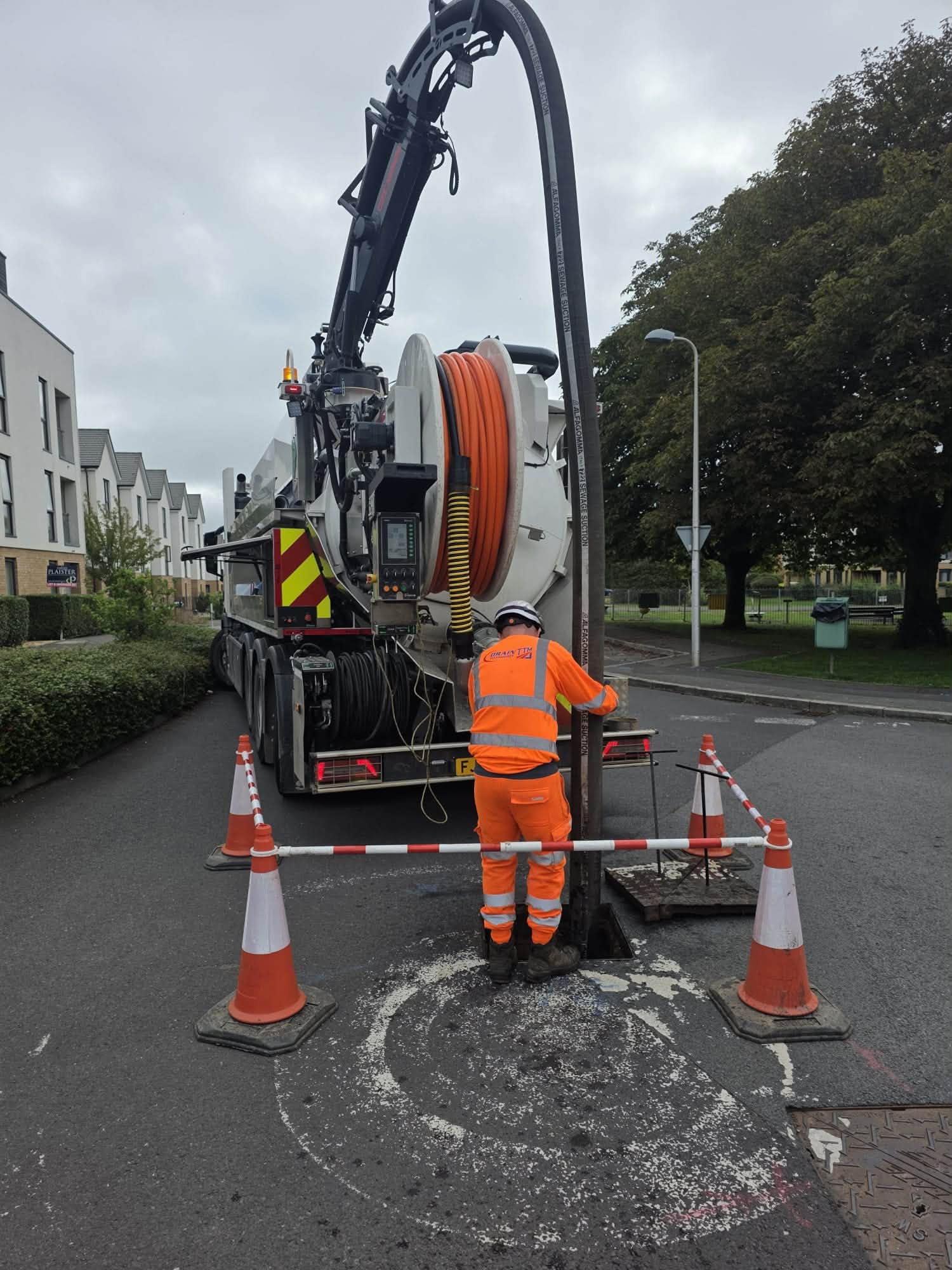 worker feeding pipe into ground