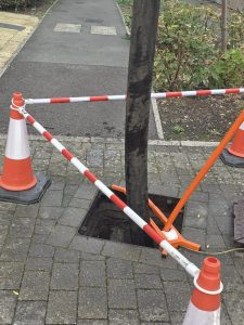 traffic cones taping off around a pipe in the ground