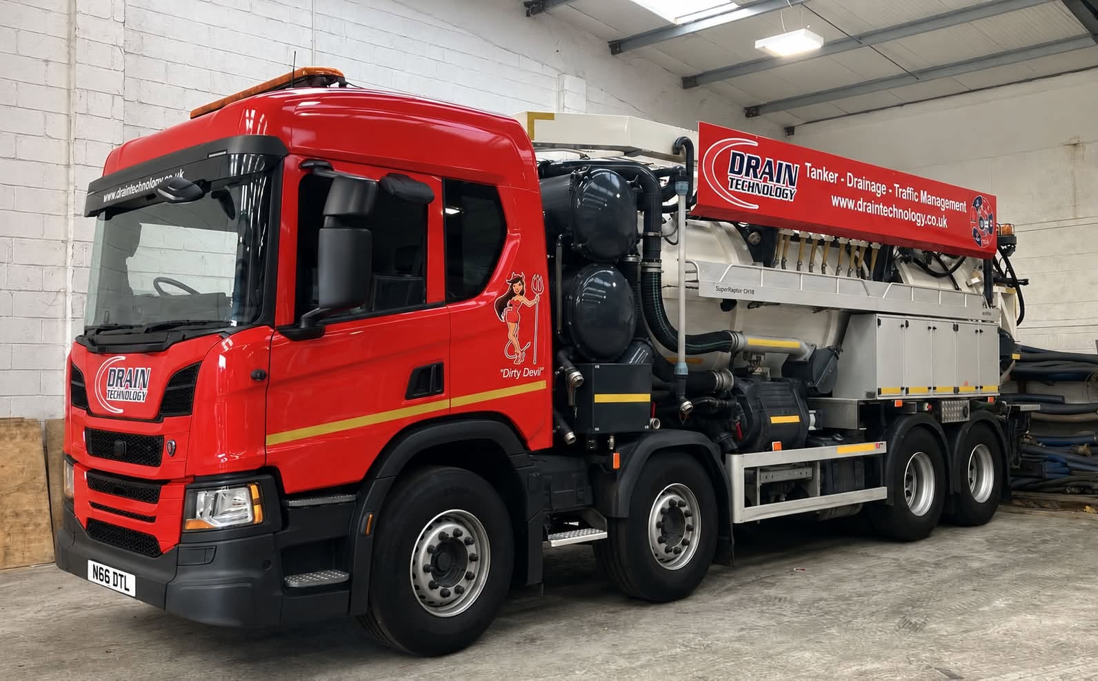 Red lorry inside a white warehouse