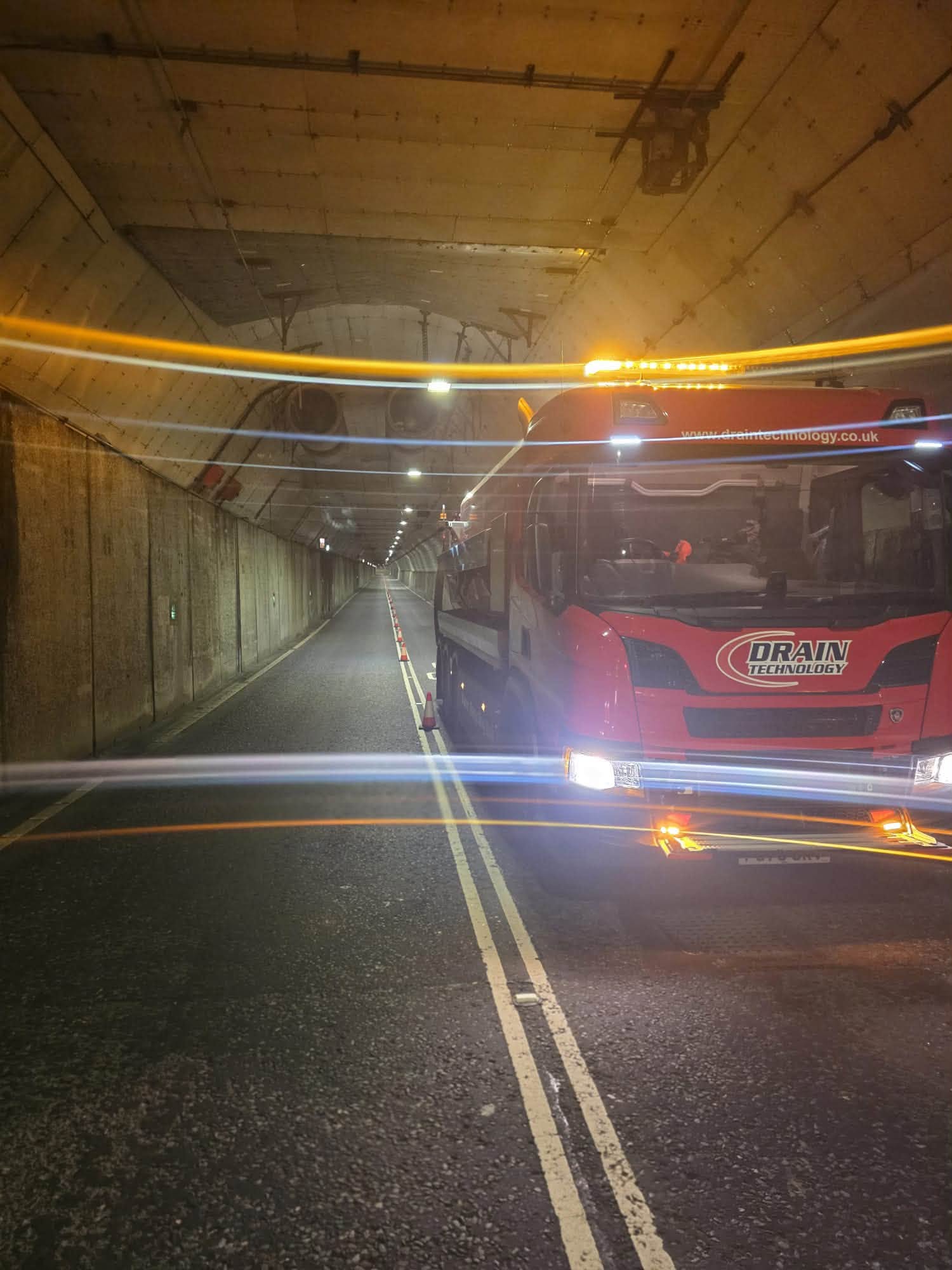 Red tanker inside a tunnel in the dark