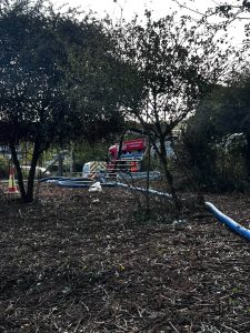 drain techology van and equipment seen through the trees