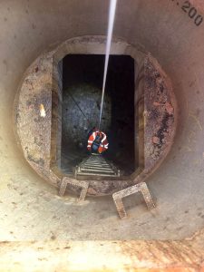 man going down a tunnel using a ladder