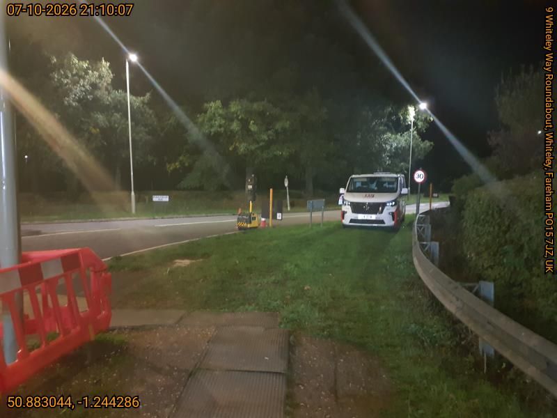 white van on the side of the road in the dark