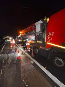 Drain Technology tanker on the side of the road at night
